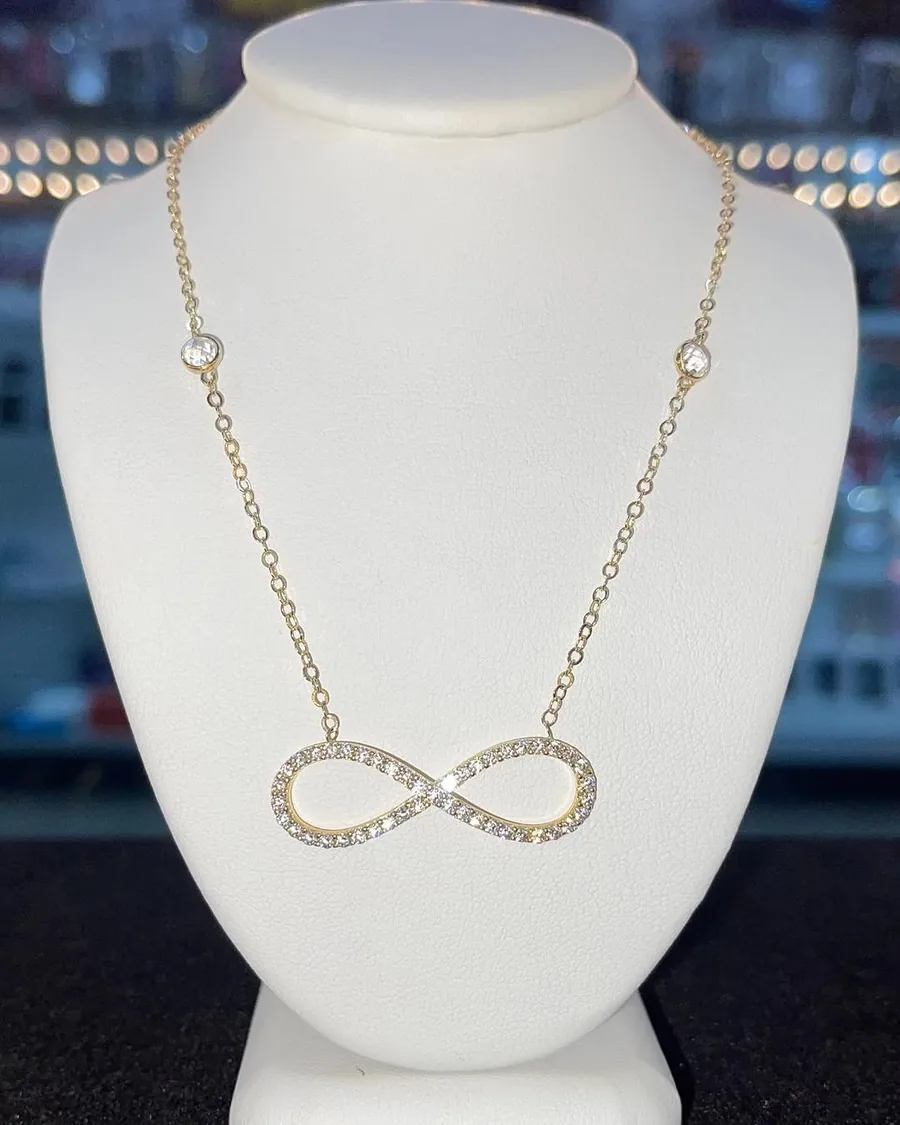 Gold station chain with a crystal infinity pendant