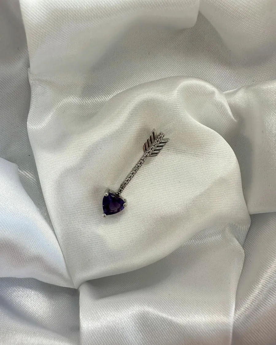 Silver arrow pendant with a purple heart stone