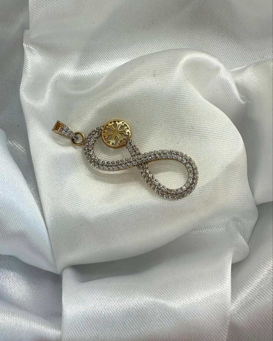 Gold and crystal infinity pendant