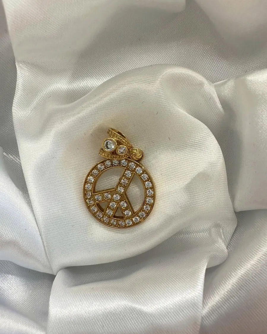 Gold peace-sign pendant set with crystals